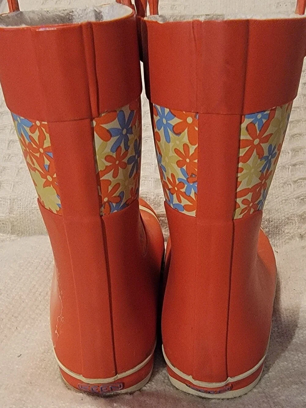 Keen orange and floral-patterned Coronado kids' waterproof rain boots